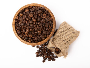 Ground coffee and beans in a bowl and burlap bag isolated on a white background.