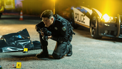Young Asian Policeman with Camera is Doing Forensic Work on a Crime Scene at Night. Police Officer...