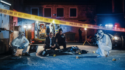 Female Police Officer and Male Investigator Working as a Team on Solving a Murder Case at the Crime...
