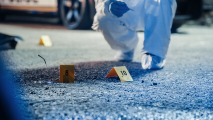 A Ground Level Shot of Evidence on a Crime Scene Investigated by Forensics. A Photo of Numbered...