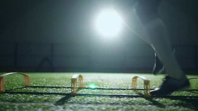 hard training of national football team, closeup view of male feet in football boots, silhouette