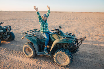 Little boy on a quad bike in the desert of Africa. Quad for children on vacation, in Egypt....