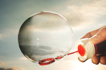 soap bubble contains a piece of sky, concept of fragility, freedom, fun, moment of life