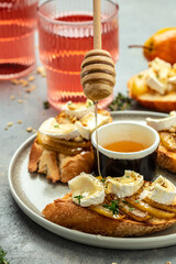 Appetizer bruschetta with pear, honey, walnut and thyme, New Years Eve or Christmas party, vertical image. top view. place for text