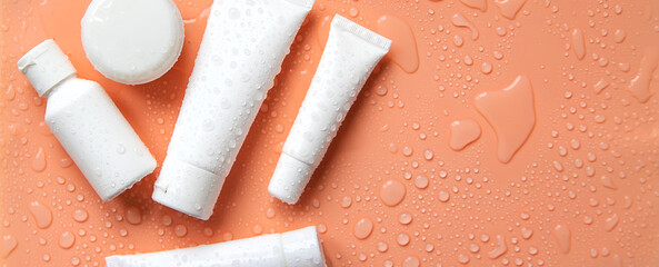 Moisturizing cosmetics on a wet background. Selective focus.