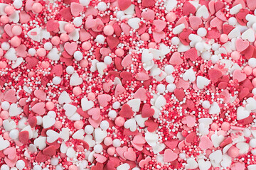 Pink heart shaped sugar sprinkles background