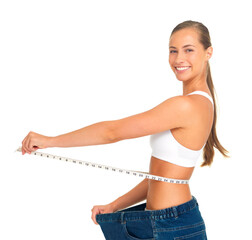 Portrait, waist and weight loss with a woman measuring her tummty in studio isolated on a white...