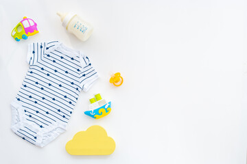 Baby boy newborn bodysuit with toys and accessories, flat lay
