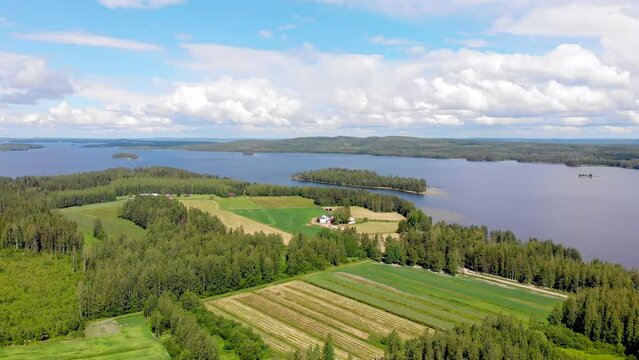 Aerial view of a lake and islands and Finnish countryside on a sunny summer day