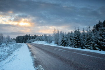 road in winter countryside at sunrise