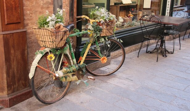 Italy: Old bicycle decorated with flowers.