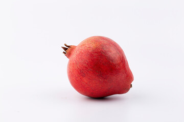 Ripe red pomegranate on a white background