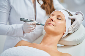 Woman in a beauty salon having needle mesotherapy treatment