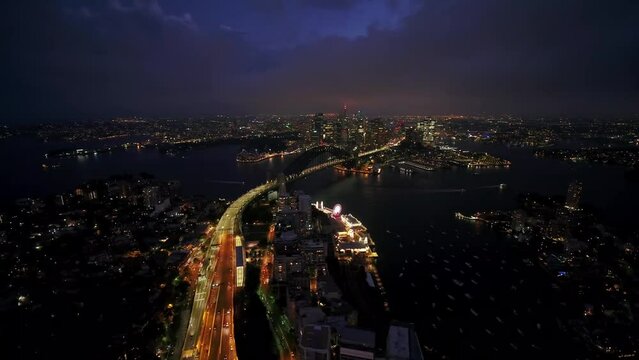 Smoth rotated view of the city of Sydney in evning. Australia. Traffic line with Harbour bridge.