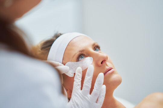 Woman having cosmetology eyebrows treatment in beauty salon