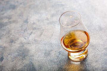 glass of whisky spirit brandy on grey concrete background