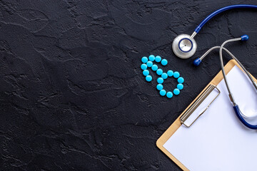 Male sign made of blue pills with doctor clipboard