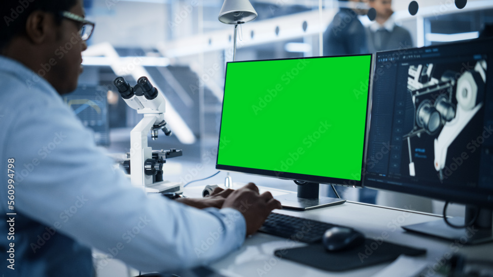 Aufkleber Software Developer Working on Computer with Green Screen Mock Up Display. Scientific Lab, Engineering Research Center with Specialists Working on Mobile Robot Development in the Background.