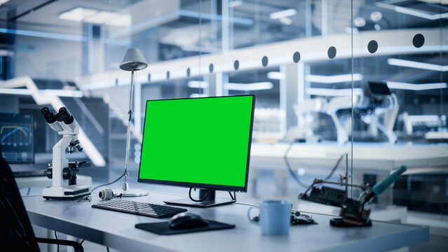 Modern Industrial Research Laboratory with Desktop Computer with Green Screen Mock Up Display. Scientific Lab, Engineering Research Center Full of High-Tech Equipment, Technology for Robot Development
