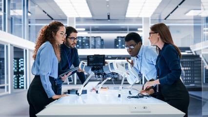 Portrait of a Young Team of Multicultural Engineers Use Computers, Insert a Circuit Board, Analyze...