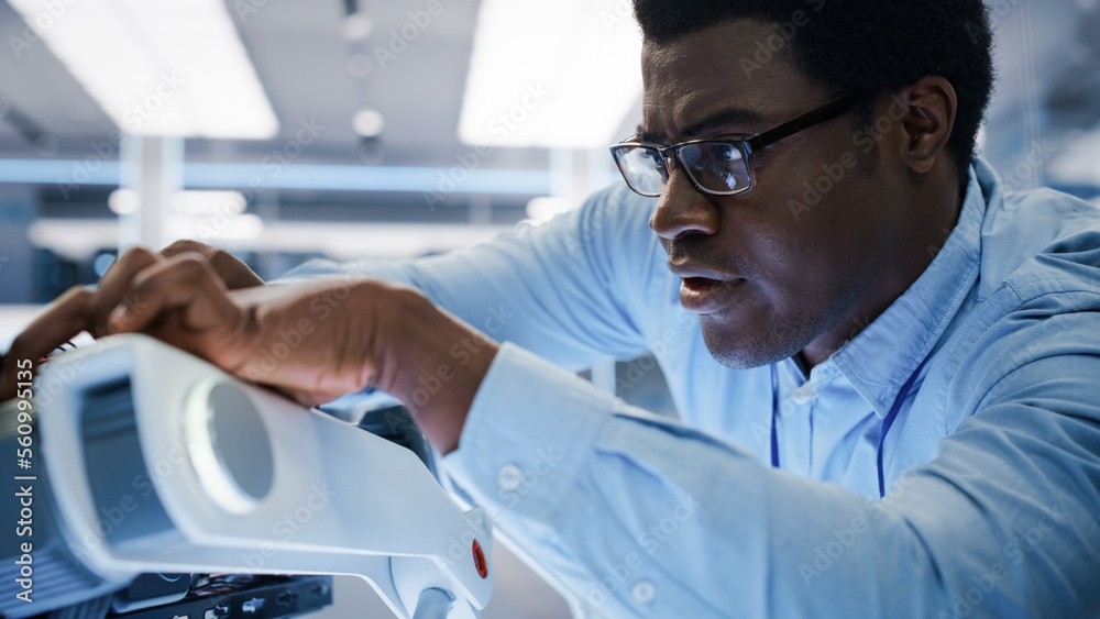 Poster Close Up of an African Engineer Using a Screwdriver While Developing a Robot Dog Concept. Black Specialist Working in High Tech Research Laboratory with Modern Equipment.