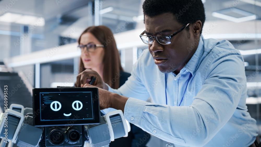 Aufkleber Close Up of an African Engineer Using a Screwdriver While Developing a Robot Dog Concept. Black Specialist Working in High Tech Research Laboratory with Modern Equipment.