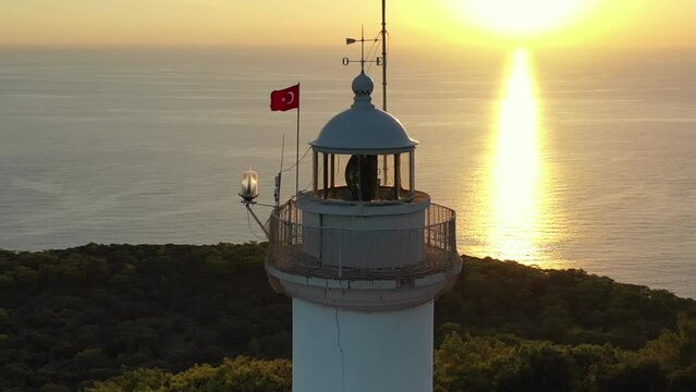 Aerial View of Gelidonya Lighthouse, Turkish Flag and Mediterranean Sea Horizon at Sunset