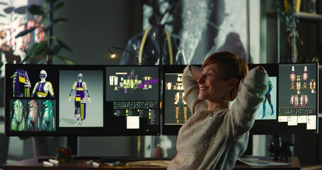 Professional Fashion Female Designer is Excited About Creating a New Collection of Women's Clothing. Young Woman Creating 3D VR Models on Computer and Makes Corrections to Paper Sketches. 