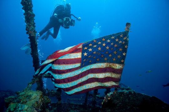 Underwaer videographer surveys American flag flying majestically over the shipwreck of the USCG cutter Duane, Key Largo, Florida