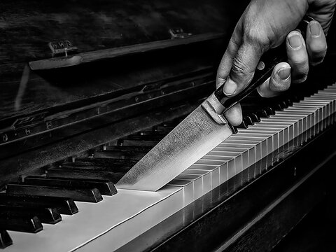 knife cutting a piano like a cake