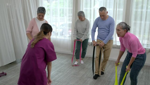 Group of senior peoples enjoy to exercise together in nursing home