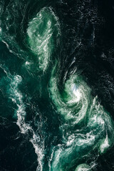 Heavy swirl of water due to strongest tidal current in the world in Saltstraumen in Norway portrait format