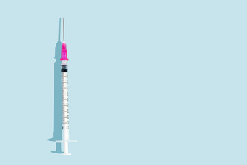medical injection syringe on blue background with.  ample copy space. Syringe for informative...