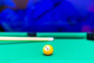 Billiard pool game one ball with cue on billiard table with green cloth.Blurred background.