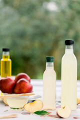 various salad vinegars in glass bottles. Front and top view. apple, lemon, strawberry, quince, grape, melon, apricot, tangerine, orange, grapefruit,