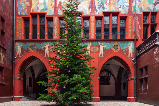 Christmas tree in the courtyard of the Rathaus building (Basel Town Hall). The building is located right on the Marktplatz and attracts with its bright red color and rich decoration