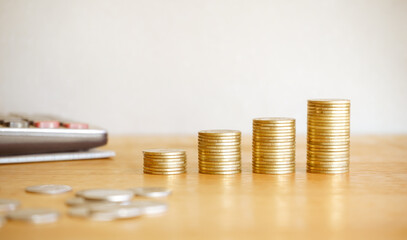 Stack of golden money coin on wood desk. Business and finance concept. 