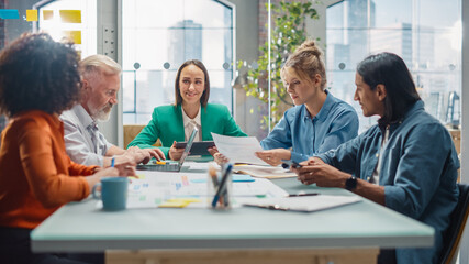 In the Stylish Modern Office Meeting Room: Diverse Group of Business Growth Marketing Professionals Use Laptop and Tablet, Discuss Project Ideas, Brainstorm Company Strategies