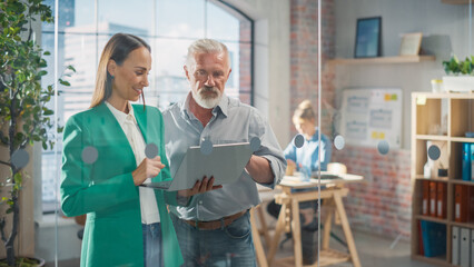 Obraz premium CEO and Chief Executive Talking About Company Business Growth, Consult Data Analysis and Use Laptop Computer. Two Professionals Discussing Revenue Increase, Market Disruption, Planning Strategy