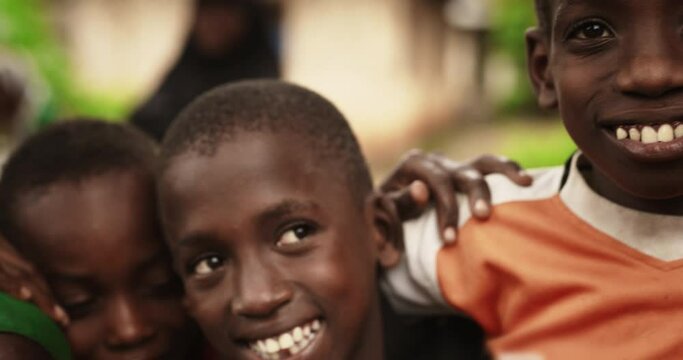 A Group Of African Children, Laughing And Playing, Little Faces Full Of Joy and Life. With Playful Poses and Funny Games, Camera Captures Beauty Of Childhood. Innocence and Purity of Live in Village