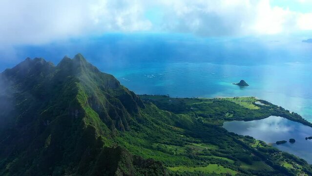 Aerial Shot Of Mountain With Green Plants By Sea Against Cloudy Sky - Kaneohe, Hawaii
