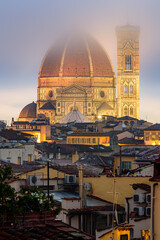Fototapeta na wymiar The illuminated Florence Cathedral in a misty dawn early morning.