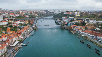 Fototapeta na wymiar Aerial flying backwards over Douro River revealing Luis I Bridge. Porto, Portugal