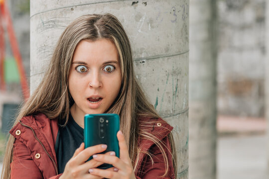 student at school looking at the mobile phone surprised