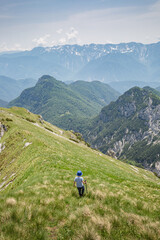 Fototapeta na wymiar Young child boy hiker conquer the peaks of amazing mountain trail Monte Montusel in Friuli-Venezia Giulia, Italy