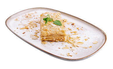 Napoleon Cake with almond on a white plate