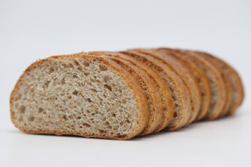 Loaf of bread, cut into slices, fresh bread.
