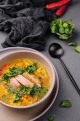Chicken soup with noodles and vegetables in bowl