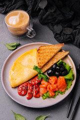 Pancakes with red fish salmon with pepper and olives