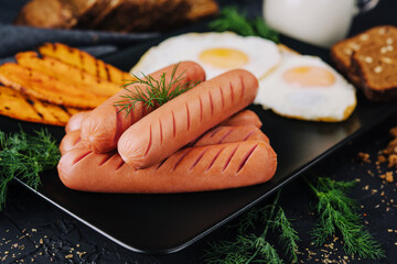 English breakfast. Sausages with eggs